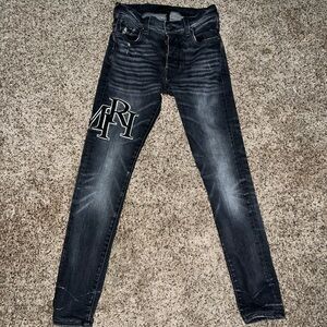 AMIRI STRAGGERED LOGO JEANS "RAIN GREY"